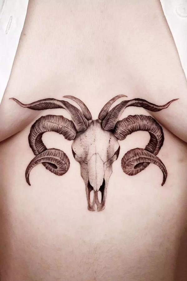 Aries ram skull sternum tattoo