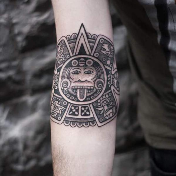 Aztec calendar inner elbow tattoo
