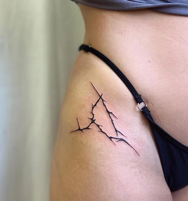 Barbed wire bikini line tattoo