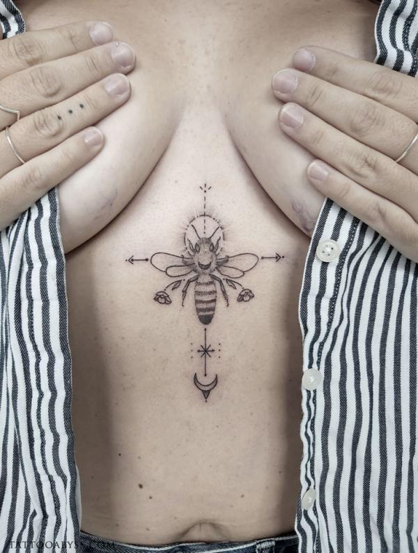Bee and flowers with sun and moon sternum tattoo