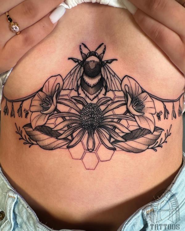 Bee and honeycomb with flowers under boob tattoo