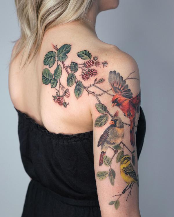 Berry and cardinal back of arm tattoo