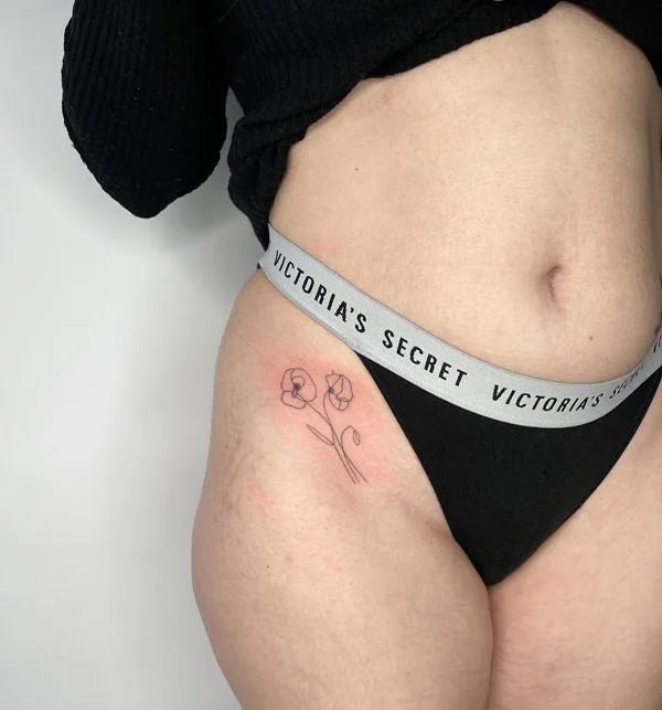 Bikini line Iris outline tattoo