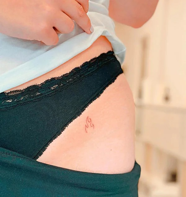 Bikini line flame tattoo