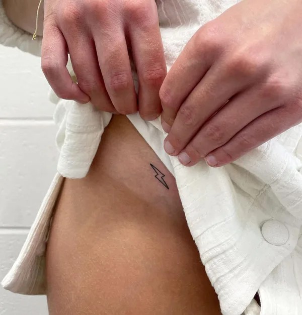 Bikini line lightning bolt tattoo