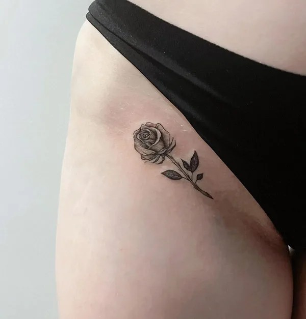 Bikini line rose tattoo black and grey