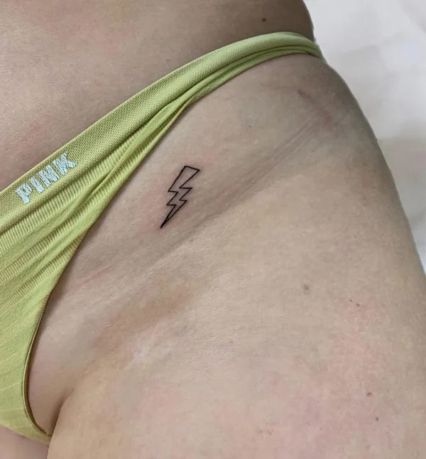 Bikini line thunderbolt tattoo