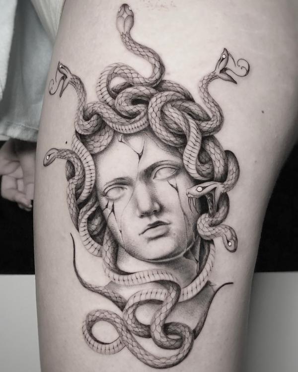 Black and grey Medusa arm tattoo