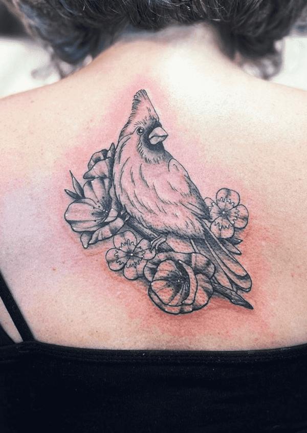 Black and grey cardinal with flowers back tattoo