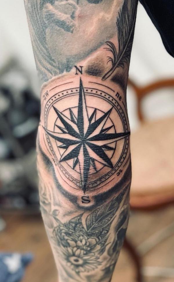 Black and grey compass elbow tattoo