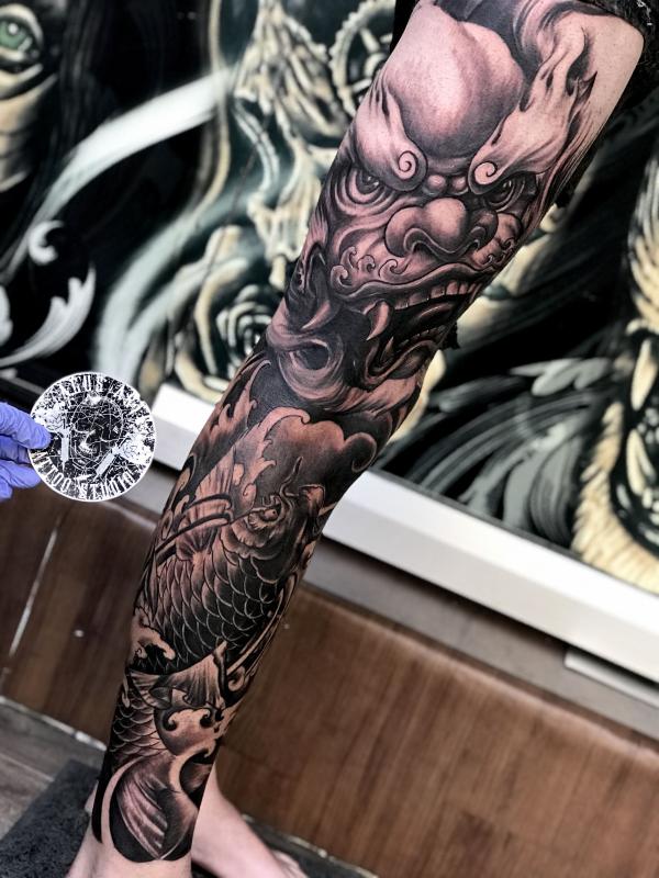 Black and grey foo dog and koi fish leg tattoo sleeve