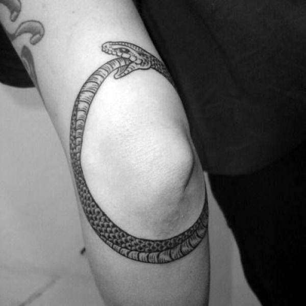 Black and grey ouroboro elbow tattoo