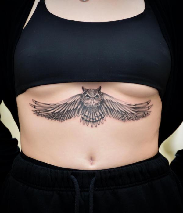 Black and grey owl sternum tattoo