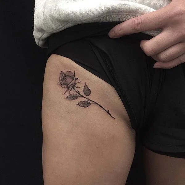 Black and grey rose bikini line tattoo