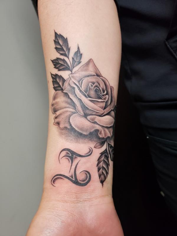 Black and grey rose with Gemini glyph tattoo