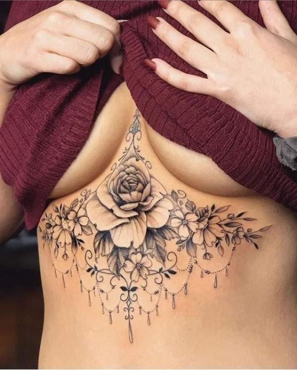 Black and grey rose with flowers sternum tattoo