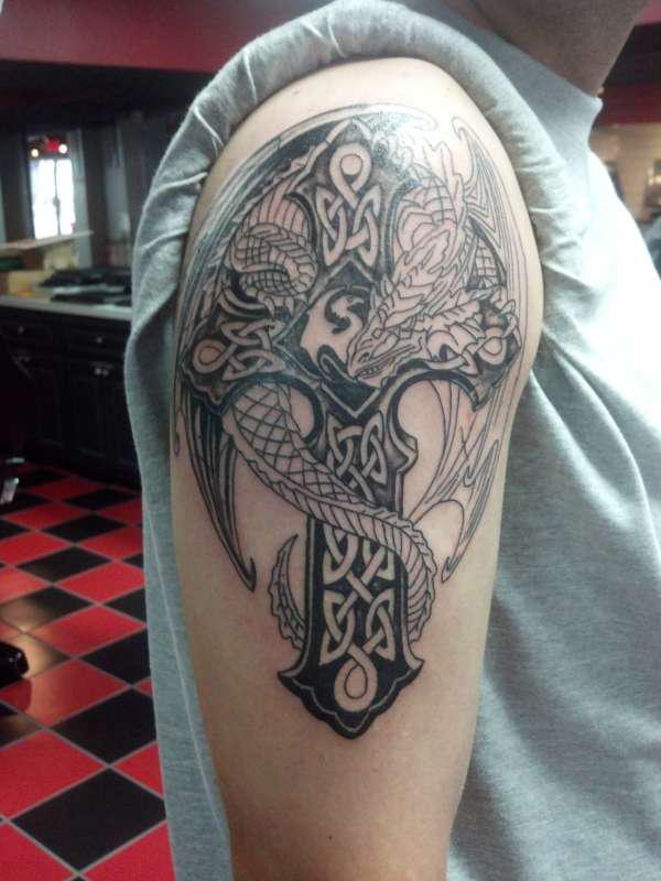 Black and white Celtic cross with dragon line work tattoo
