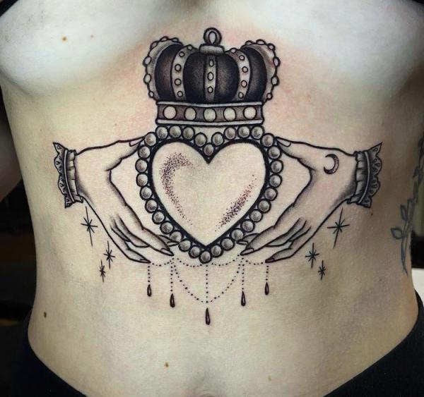 Black and white Claddagh sternum tattoo
