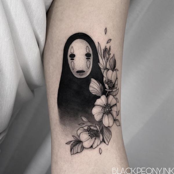 Black and white No Face with flower tattoo