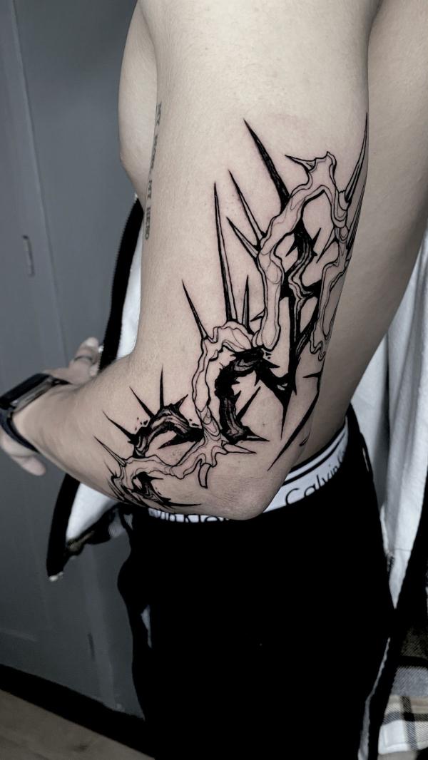 Black and white barbed wire elbow tattoo