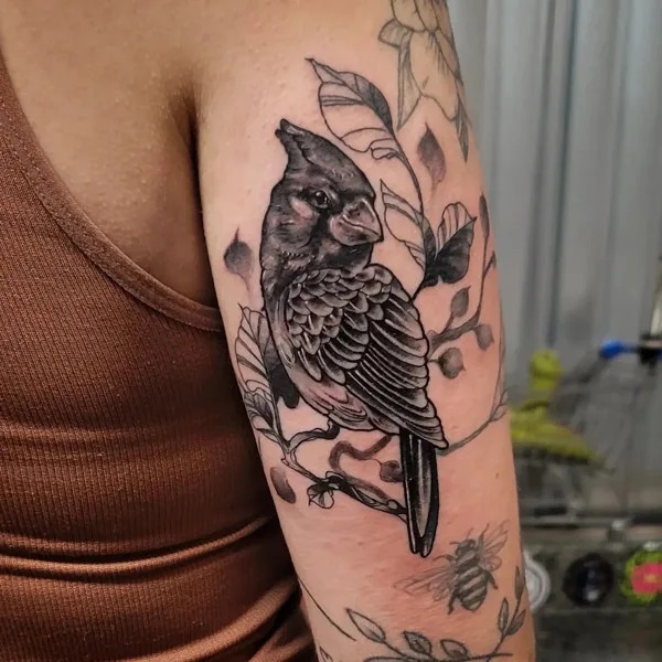 Black and white cardinal back of arm tattoo