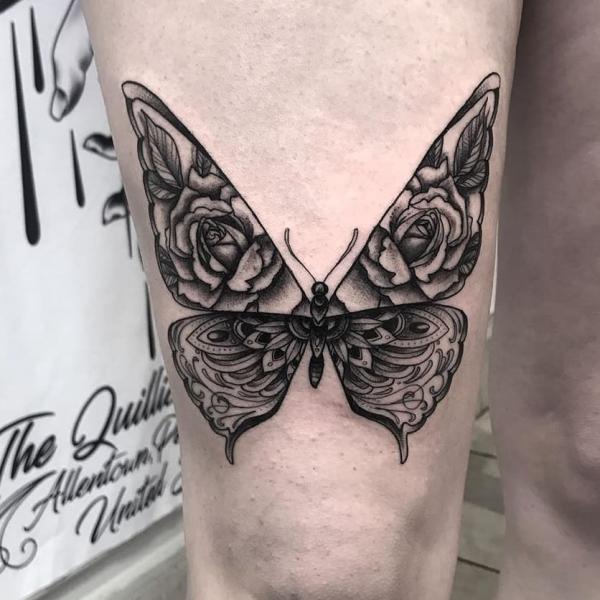 Black and white floral butterfly above knee tattoo