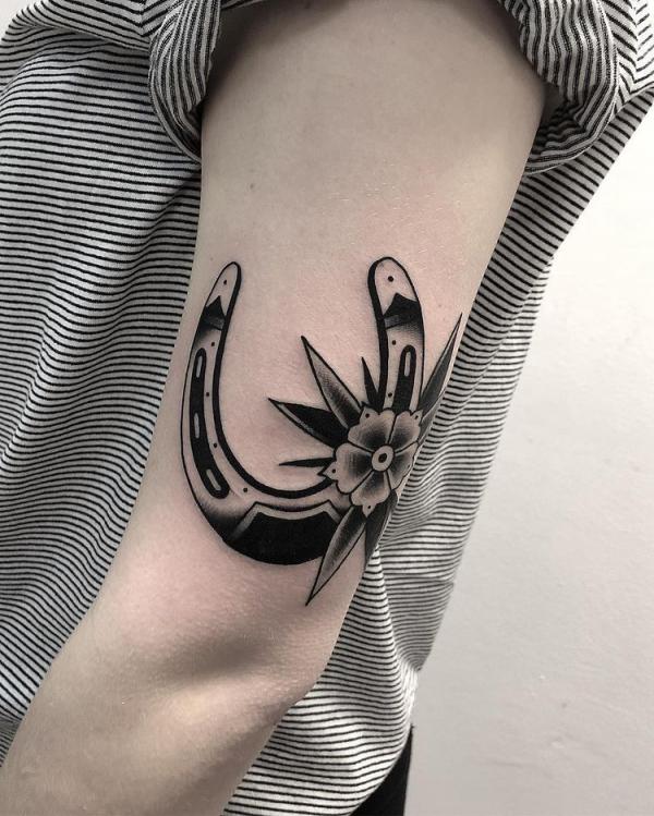 Black and white flower horseshoe tattoo