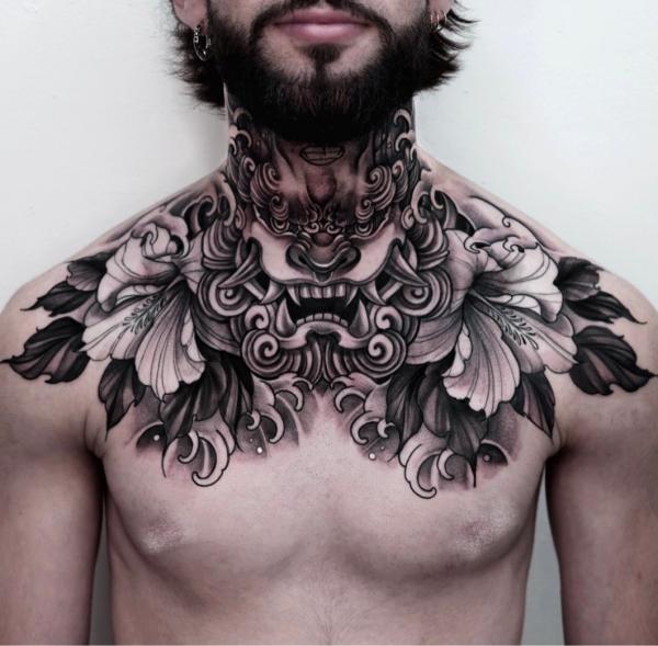 Black and white foo dog with flower collar tattoo for men
