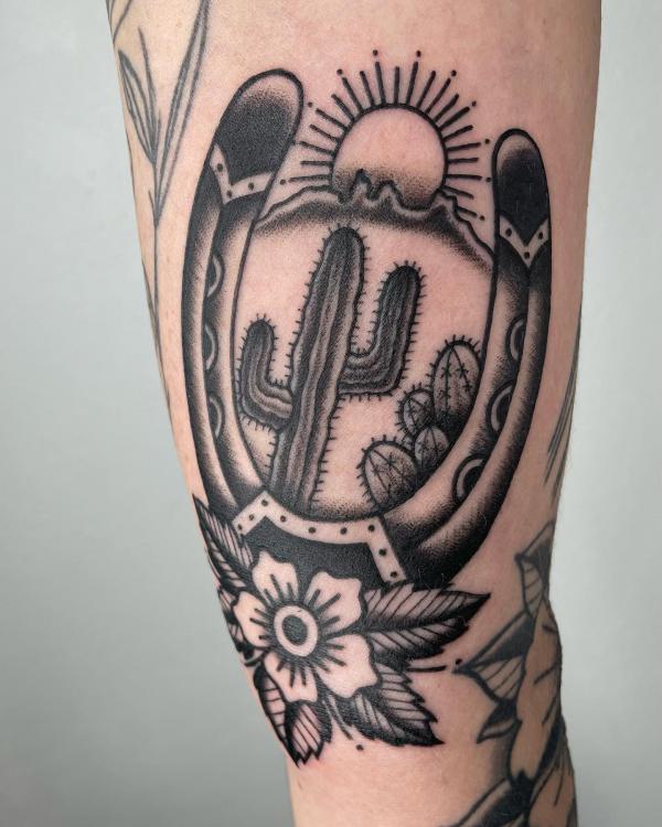 Black and white horseshoe and cactus tattoo traditional