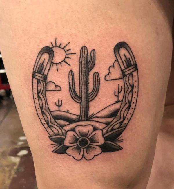 Black and white horseshoe and cactus tattoo
