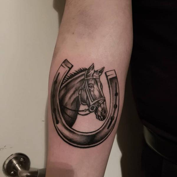 Black and white horseshoe with horse head tattoo