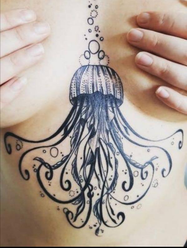 Black and white jellyfish sternum tatttoo