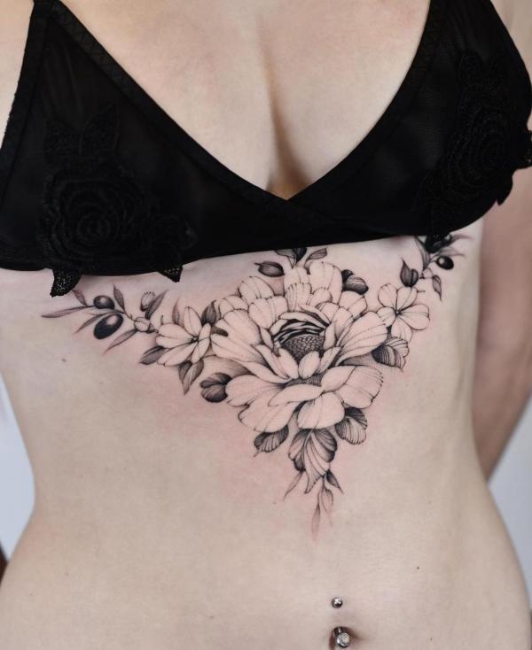 Black and white peony sternum tattoo