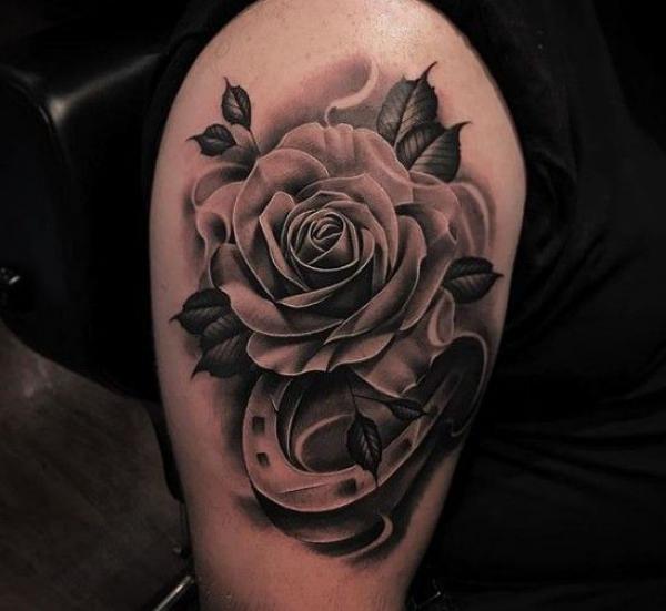 Black and white rose and horseshoe tattoo