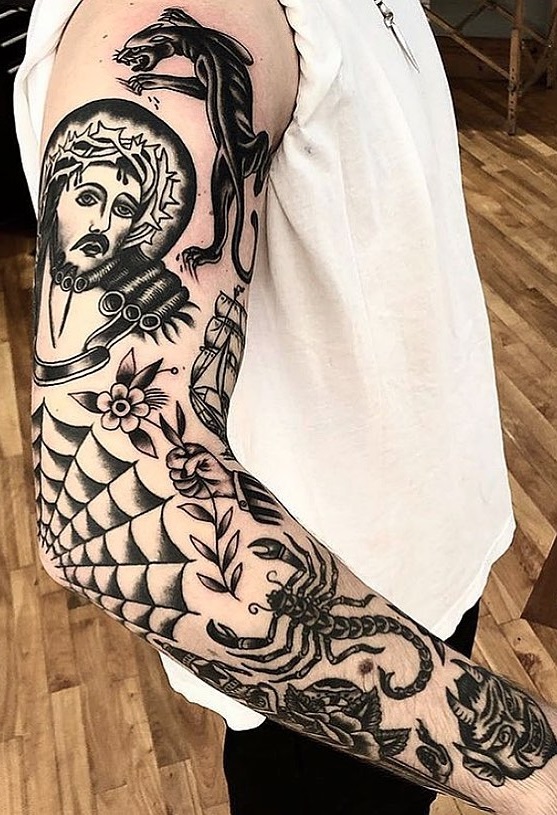 Black and white spiderweb tattoo on elbow