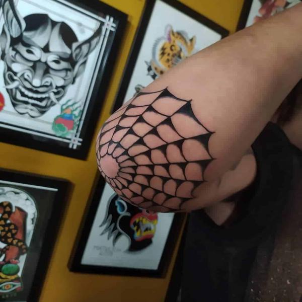Black and white traditional Spiderweb elbow tattoo