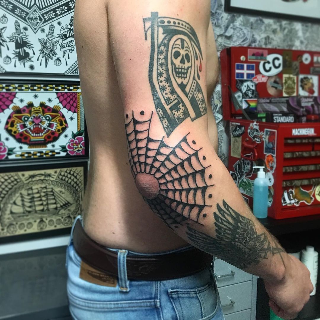 Black and white traditional spider web elbow tattoo for men