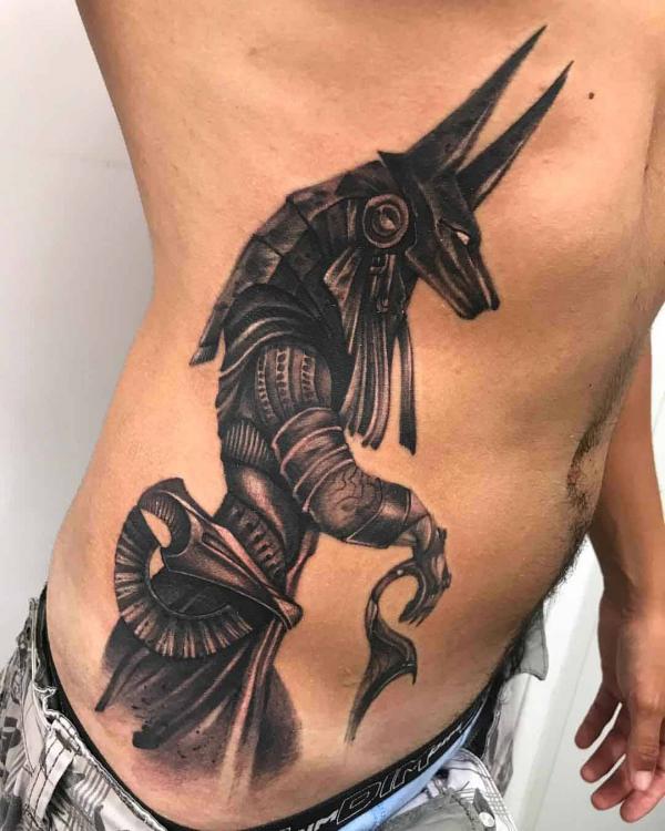 Blackwork Anubis warrior side tattoo