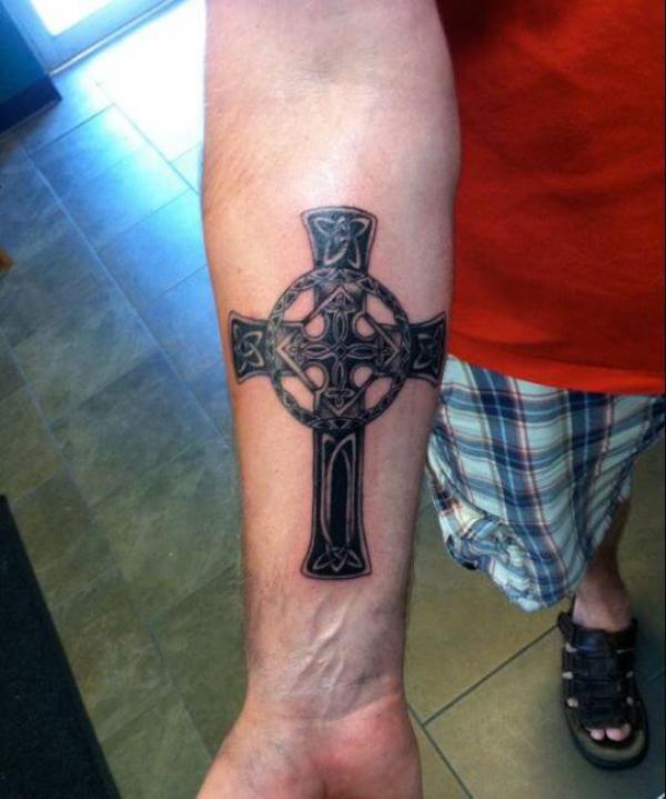 Blackwork Celtic cross forearm tattoo