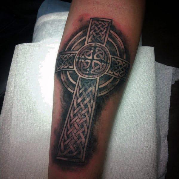 Blackwork Celtic cross with Trinity knot forearm tattoo