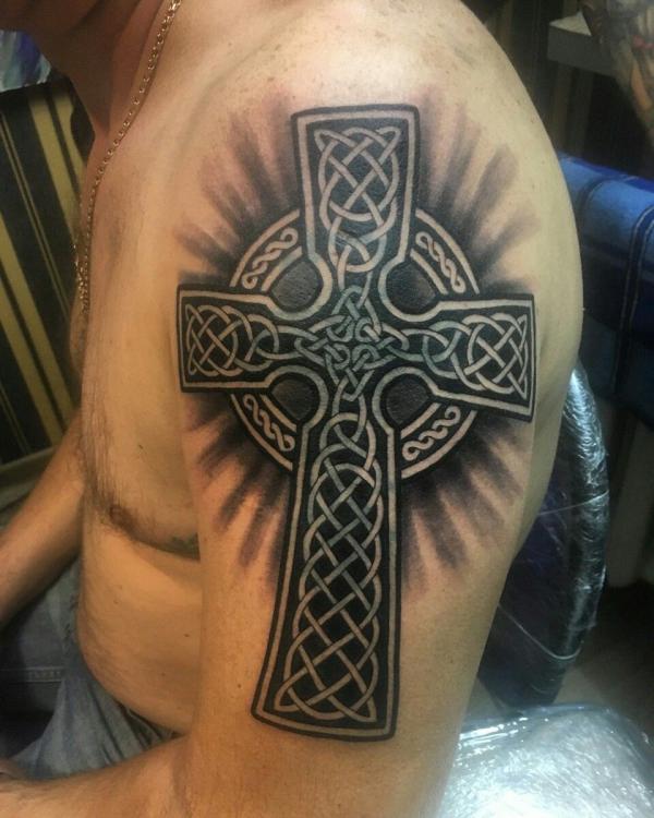 Blackwork Celtic cross with halo arm tattoo