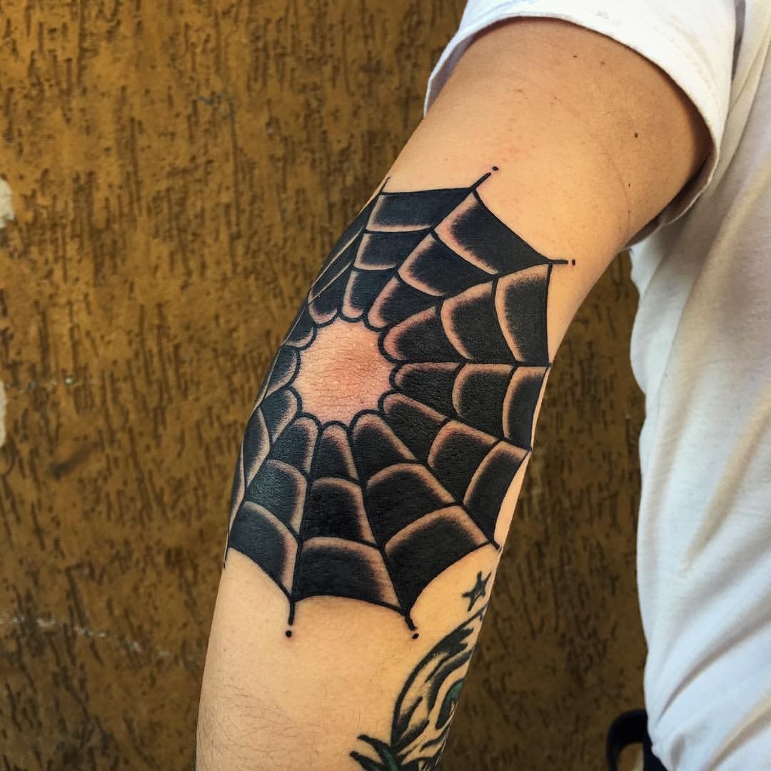 Blackwork elbow spiderweb tattoo
