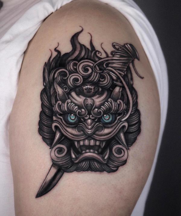 Blackwork foo dog with dagger tattoo