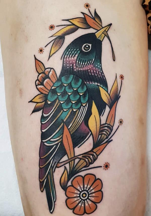 Blue Jay perched on branch and holding leaf in mouth tattoo traditional