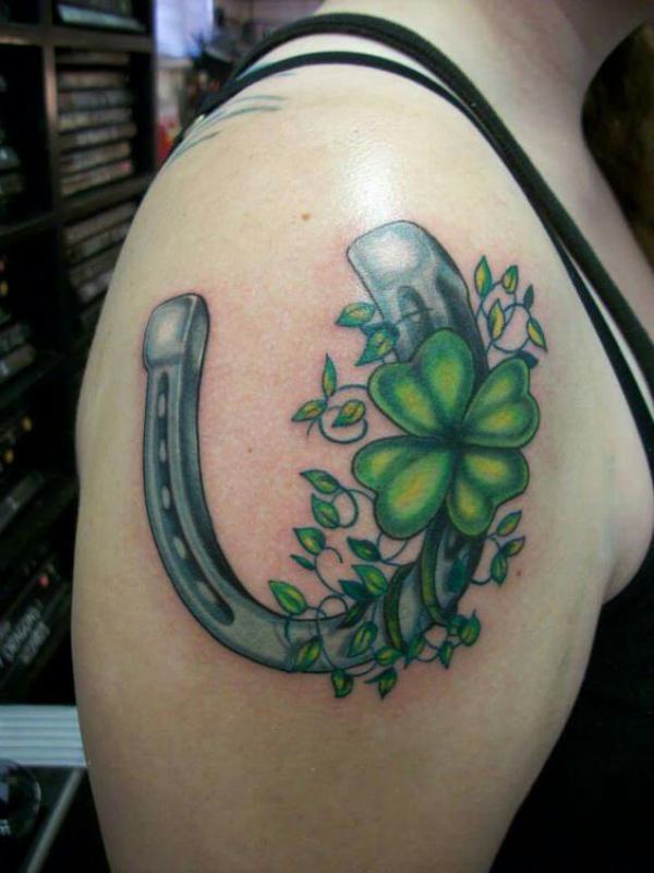 Blue horseshoe with shamrock shoulder tattoo