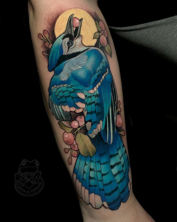 Blue jay eating wild fruit under moon tattoo