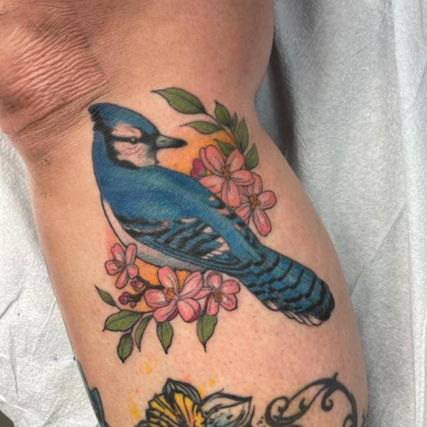 Blue jay with flowers tattoo