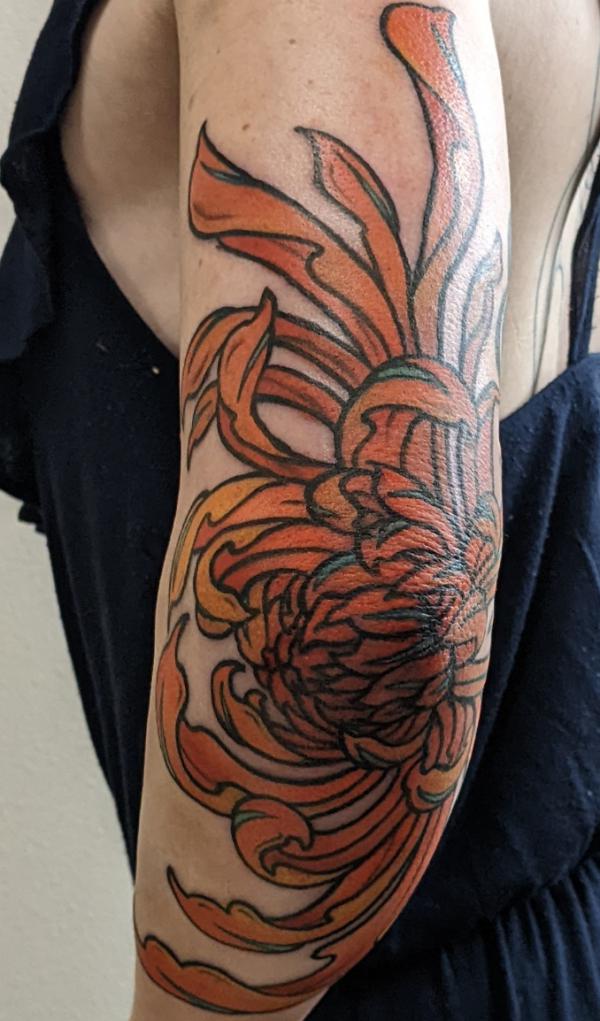 Brown chrysanthemum elbow tattoo