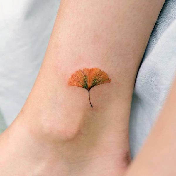 Brown ginkgo ankle tattoo