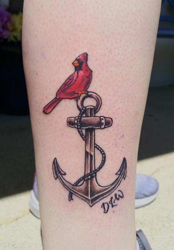 Cardinal perched on anchor tattoo